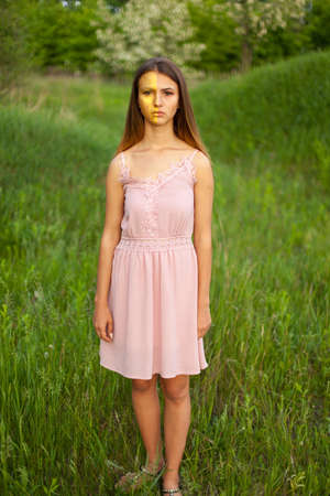 sexual girl has dissolved long hair sunny in the afternoon opposite blossoming white acaciaの写真素材