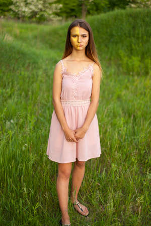 sexual girl has dissolved long hair sunny in the afternoon opposite blossoming white acaciaの写真素材