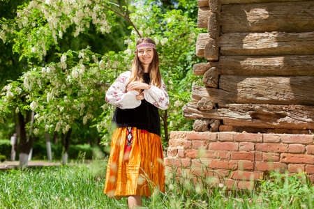 ukrainian girl posing in a rustic style in national dress in nature summer dayの写真素材