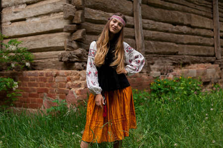 ukrainian girl posing in a rustic style in national dress in nature summer dayの写真素材