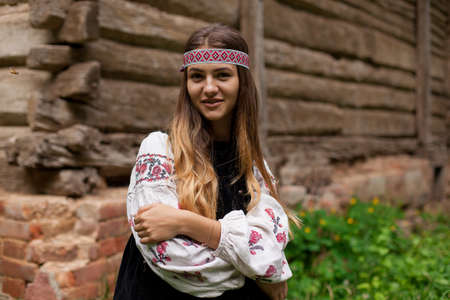 ukrainian girl posing in a rustic style in national dress in nature summer dayの写真素材