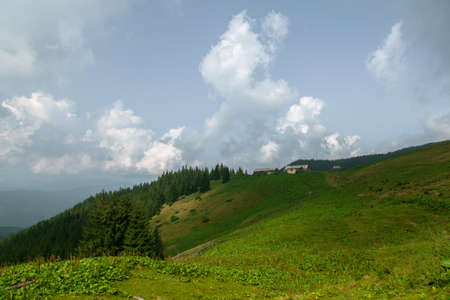 Wooden hut in Carpathians on the gorge under a cloudy skyの写真素材