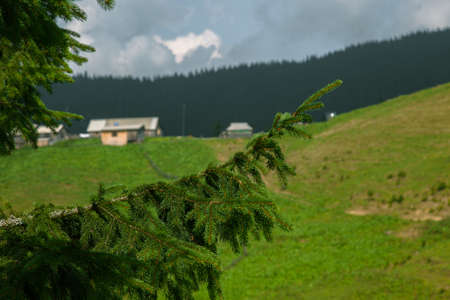 Wooden hut in Carpathians on the gorge under a cloudy skyの写真素材