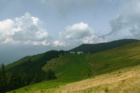 Wooden hut in Carpathians on the gorge under a cloudy skyの写真素材