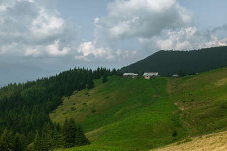 Wooden hut in Carpathians on the gorge under a cloudy skyの写真素材