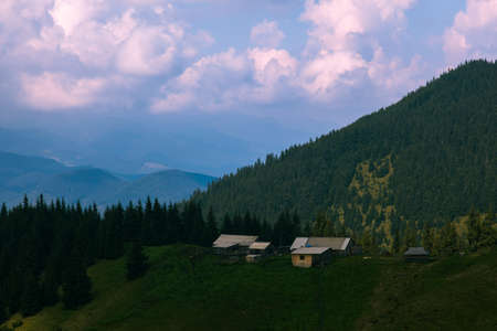 Wooden hut in Carpathians on the gorge under a cloudy skyの写真素材