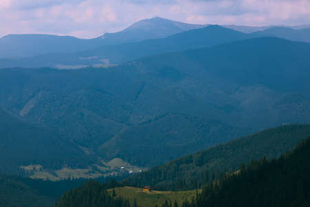 Wooden hut in Carpathians on the gorge under a cloudy skyの写真素材