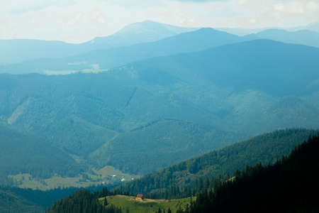 Wooden hut in Carpathians on the gorge under a cloudy skyの写真素材