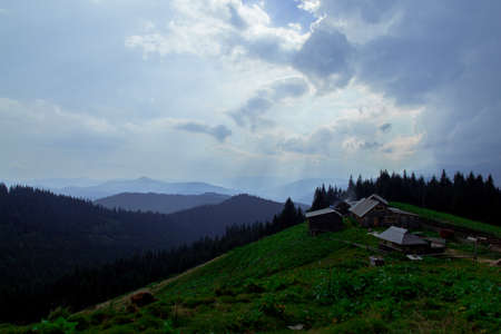 Wooden hut in Carpathians on the gorge under a cloudy skyの写真素材
