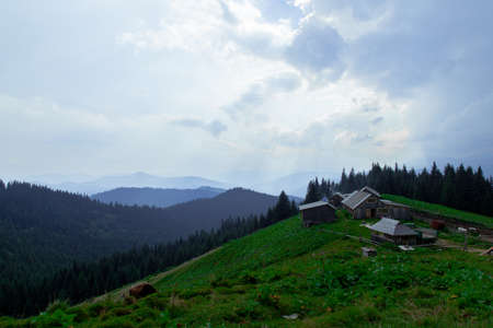 Wooden hut in Carpathians on the gorge under a cloudy skyの写真素材