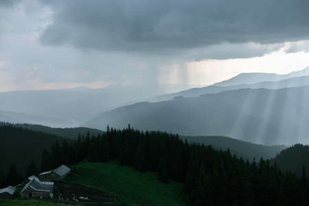 Wooden hut in Carpathians on the gorge under a cloudy skyの写真素材