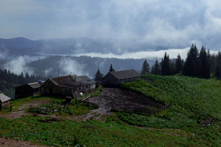 wooden hut in the Carpathian Mountains raises fogの写真素材