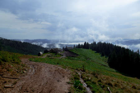 wooden hut in the Carpathian Mountains raises fogの写真素材