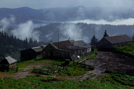 wooden hut in the Carpathian Mountains raises fogの写真素材