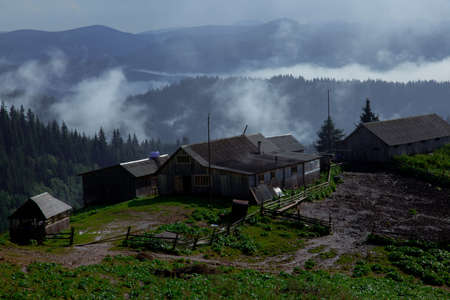 wooden hut in the Carpathian Mountains raises fogの写真素材