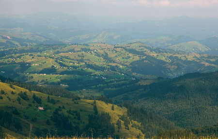 Wooden hut in Carpathians on the gorge under a cloudy skyの写真素材