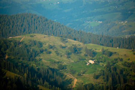 Wooden hut in Carpathians on the gorge under a cloudy skyの写真素材