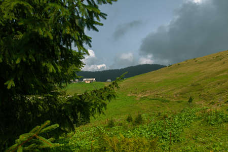 Wooden hut in Carpathians on the gorge under a cloudy skyの写真素材