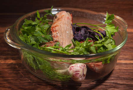 lightly cooked steak in a glass pan under the ovenの写真素材