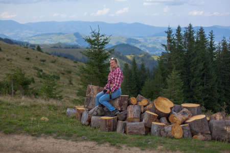 girl in stylish clothes high in the carpathians takes a selfie for social networksの写真素材