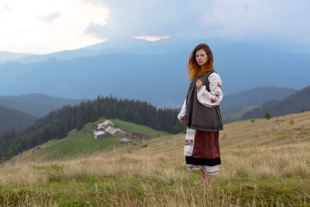 attractive girl in Ukrainian embroidery high in the carpathian mountainsの写真素材