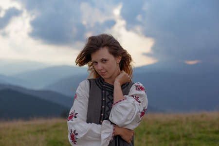 attractive girl in Ukrainian embroidery high in the carpathian mountainsの写真素材