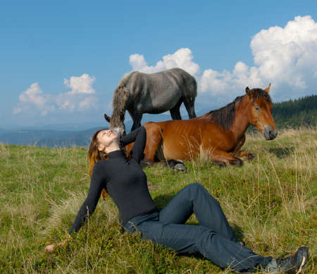 attractive sports girl high in the carpathians with horsesの写真素材