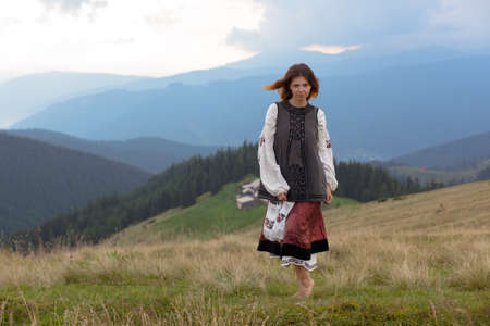 attractive girl in Ukrainian embroidery high in the carpathian mountainsの写真素材