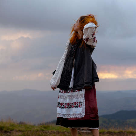 attractive girl in Ukrainian embroidery high in the carpathian mountainsの写真素材