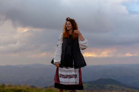 attractive girl in Ukrainian embroidery high in the carpathian mountainsの写真素材