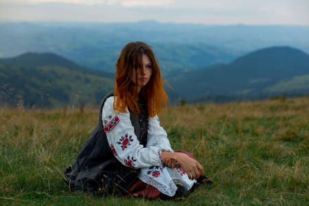 attractive girl in Ukrainian embroidery high in the carpathian mountainsの写真素材
