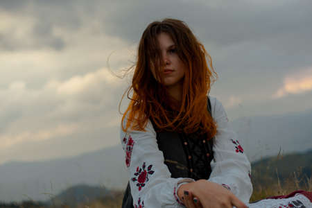 attractive girl in Ukrainian embroidery high in the carpathian mountainsの写真素材
