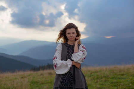 attractive girl in Ukrainian embroidery high in the carpathian mountainsの写真素材