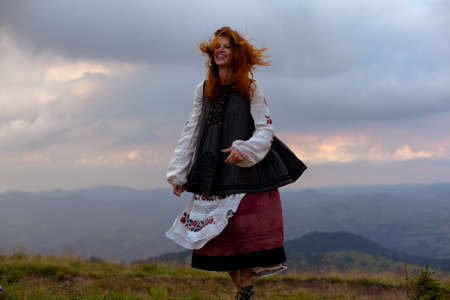 attractive girl in Ukrainian embroidery high in the carpathian mountainsの写真素材