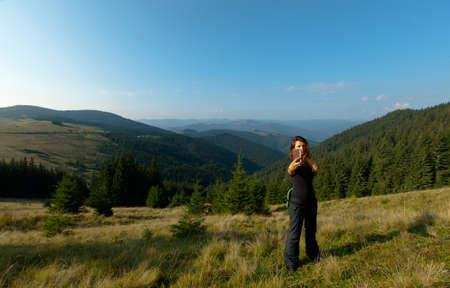 girl in the carpathian mountains makes selfie summer dayの写真素材