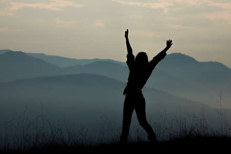 girl tourist high in the mountains sunset sun fog tops of the carpathiansの写真素材