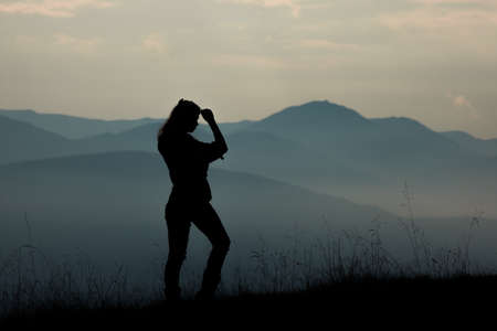 girl tourist high in the mountains sunset sun fog tops of the carpathiansの写真素材