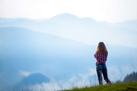 girl tourist high in the mountains sunset sun fog tops of the carpathians