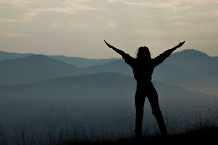 girl tourist high in the mountains sunset sun fog tops of the carpathiansの写真素材