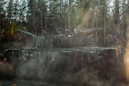 real battle panzer in the Donbass - eastern Ukraine is driving fast in a coniferous forestの写真素材