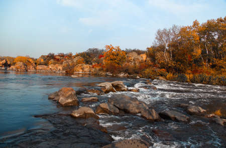 Stormy river rolls over stonesの写真素材