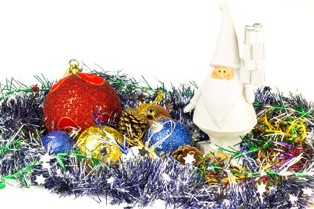 White Santa figure, christmas balls with tinsel isolated on white backgroundの写真素材