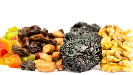 Mix of healthy nuts and dried fruits isolated on white background, selective focusの写真素材