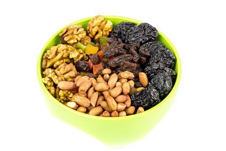 Mix of healthy nuts and dry fruits in plate isolated on white background, top viewの写真素材