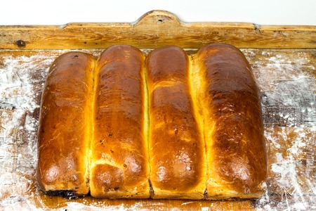 Hot, fresh baked homemade sweet pies, strudel, on wooden background with flour, top viewの写真素材