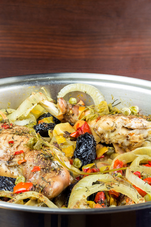 Healthy food, stewed dietary rabbit meat with various vegetables and fruit in pan, close-up view, vertical image.の写真素材