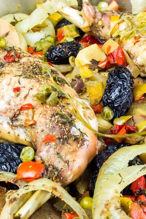 Healthy food, stewed dietary rabbit meat with various vegetables and fruit in pan, close-up view, vertical image.の写真素材