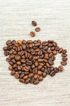 Coffee beans in shape of cup, vertical imageの写真素材