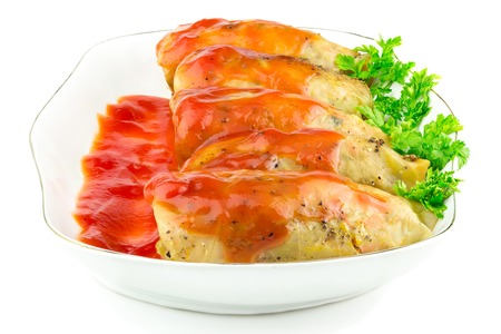 Cabbage roll with tomato sauce and parsley in plate, isolated on white background, in ukrainian holubtsiの写真素材