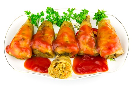 Cabbage roll with tomato sauce and parsley in plate, isolated on white background, in ukrainian holubtsiの写真素材
